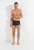 Full-body view of a men model wearing HO black print modal/viscose/tencel Boxer Briefs