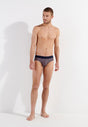 Full-body view of a men model wearing HO navy print cotton Comfort Briefs