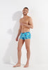 Full-body view of a men model wearing HO blue print  Swim Shorts