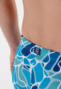 Close-up view of a men model wearing HO blue print  Swim Shorts