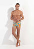 Full-body view of a men model wearing HO orange print  Swim Shorts