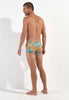 General view of a men model wearing HO orange print  Swim Shorts