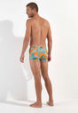 General view of a men model wearing HO orange print  Swim Shorts