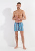Full-body view of a men model wearing HO turquoise print  Beach Boxer