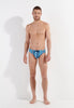 Full-body view of a men model wearing HO turquoise print  Swim Mini Briefs