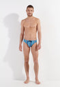 Full-body view of a men model wearing HO turquoise print  Swim Mini Briefs