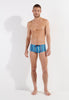 Full-body view of a men model wearing HO turquoise print  Swim Trunk