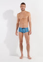 Full-body view of a men model wearing HO turquoise print  Swim Trunk