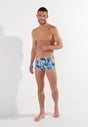 Full-body view of a men model wearing HO blue print  Swim Shorts