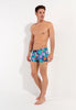 Full-body view of a men model wearing HO navy print  Swim Shorts