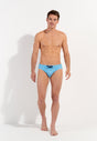 Full-body view of a men model wearing HO turquoise print  Swim Mini Briefs