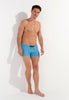 Full-body view of a men model wearing HO turquoise print  Swim Shorts