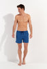 Full-body view of a men model wearing HO blue print  Beach Boxer
