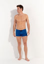Full-body view of a men model wearing HO blue print  Swim Shorts
