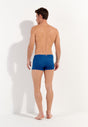 General view of a men model wearing HO blue print  Swim Shorts