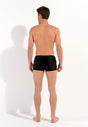 General view of a men model wearing HO black  Swim Shorts