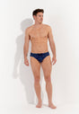 Full-body view of a men model wearing HO navy print  Swim Mini Briefs