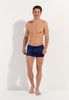 Full-body view of a men model wearing HO navy print  Swim Shorts