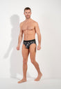 Full-body view of a men model wearing HO black print modal/viscose/tencel Mini Briefs