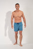 Full-body view of a men model wearing HO blue print  Beach Boxer