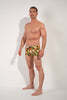 Full-body view of a men model wearing HO navy print  Swim Shorts