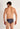 Back view of a men model wearing HO black print  Tanga Briefs