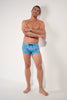 Full-body view of a men model wearing HO blue print  Swim Shorts