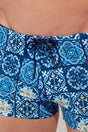Close-up view of a men model wearing HO blue print  Swim Shorts