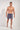 Full-body view of a men model wearing HO multicolor stripes  Beach Boxer