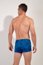 Back view of a men model wearing HO blue print  Swim Shorts