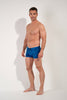 Full-body view of a men model wearing HO blue print  Swim Shorts