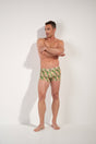 Full-body view of a men model wearing HO green print  Swim Shorts