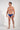 Full-body view of a men model wearing HO navy print  Swim Mini Briefs