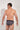 Back view of a men model wearing HO navy print modal/viscose/tencel Mini Briefs