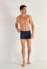 Full-body view of a men model wearing HO navy print modal/viscose/tencel Comfort Boxer Briefs