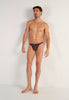 Full-body view of a men model wearing HO black/red  G-String