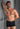 Full-body view of a men model wearing HO black cotton Boxer Briefs