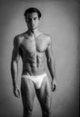 Front view of a men model wearing HO white cotton Tanga Briefs