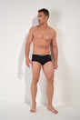 Full-body view of a men model wearing HO black  Swim Midi Briefs