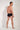 General view of a men model wearing HO black  Swim Midi Briefs