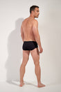 General view of a men model wearing HO black  Swim Midi Briefs