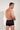 Back view of a men model wearing HO black  Swim Shorts