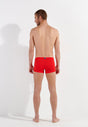 General view of a men model wearing HO red  Swim Shorts